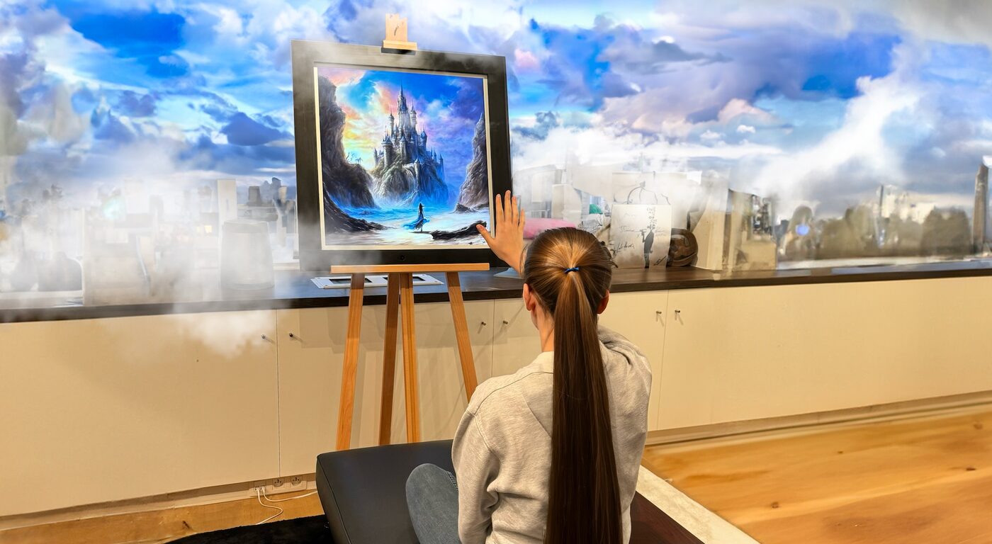 A person controlling a Zoetrope frame on an easel with a hand gesture